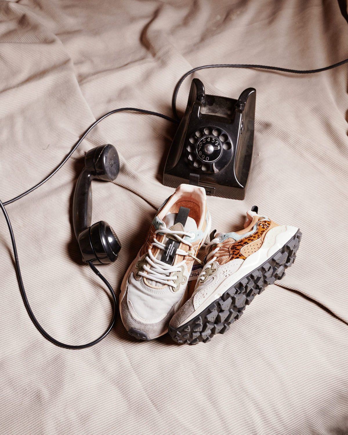 Sneakers accanto a un telefono d'epoca